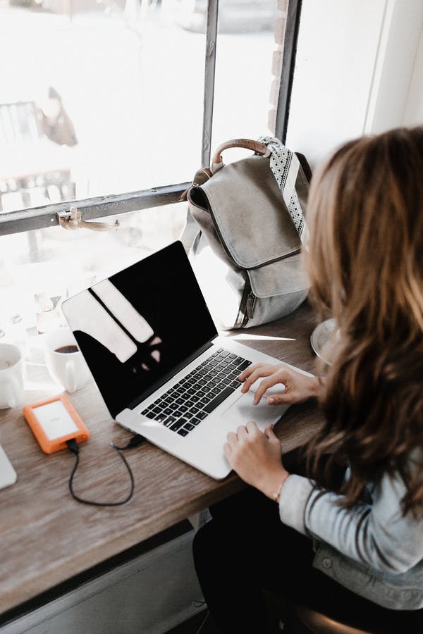 woman working with laptop outside home